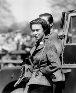 With Camera Ready, the Princess Watched Badminton, Gloucester : Wearing a flower With Camera Ready, the Princess Watched Badminton, Gloucester : Wearing a flower