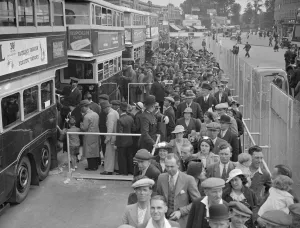 The Epsom Derby Summer Race Meeting. Derby Day crowds boarding buses at Morden The Epsom Derby Summer Race Meeting. Derby Day crowds boarding buses at Morden