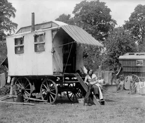 A gypsy woman sitting on the steps to her Romany caravan in the gypsy camp on Epsom Downs A gypsy woman sitting on the steps to her Romany caravan in the gypsy camp on Epsom Downs