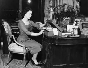 HM Queen Elizabeth II at her desk in Buckingham Palace as she opens one of the boxes HM Queen Elizabeth II at her desk in Buckingham Palace as she opens one of the boxes
