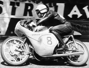 Isle of Man: Japanese rider Taniguchi on a Honda machine racing round the Manx track Isle of Man: Japanese rider Taniguchi on a Honda machine racing round the Manx track