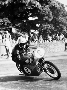 Isle of Man: N Taniguchi of Japan takes the corner at speed, riding a 125cc Japanese honda Isle of Man: N Taniguchi of Japan takes the corner at speed, riding a 125cc Japanese honda