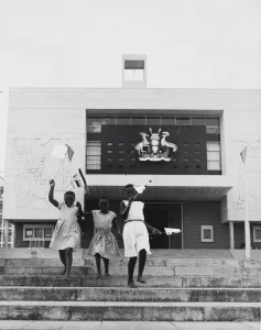 Kampala, Uganda, three young girls run down the steps in front of the new parliament Kampala, Uganda, three young girls run down the steps in front of the new parliament