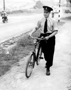 A Kent police officer with his bicycle. 26th July 1952 A Kent police officer with his bicycle. 26th July 1952