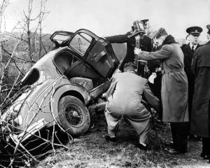 Police and photorgraphers are seen with the wreck of the black Jaguar car in which Police and photorgraphers are seen with the wreck of the black Jaguar car in which