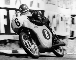 Switzerlands Luigi Taveri riding a Honda, speeding out of the dip at Governor's Switzerlands Luigi Taveri riding a Honda, speeding out of the dip at Governor's