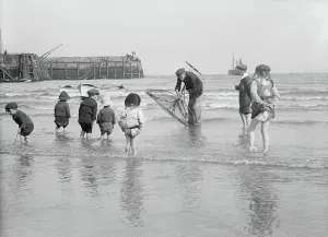 Maritime History England Prints: Children with their feet in the water on the beach