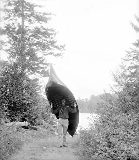 Adirondack Mountains Collection: Carrying canoe in the Adirondack Mountains, 1902 (b / w photo)
