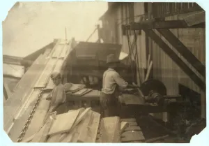 Charlie McBride aged 12 takes wood from a chute for 10 hours at Miller & Vidor Lumber Charlie McBride aged 12 takes wood from a chute for 10 hours at Miller & Vidor Lumber