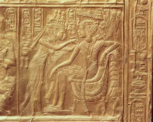 Detail from the little shrine of Tutankhamun depicting the Queen fastening a necklace Detail from the little shrine of Tutankhamun depicting the Queen fastening a necklace