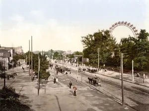 View down the main avenue in The Prater Vienna with the Giant Ferris Wheel on the right View down the main avenue in The Prater Vienna with the Giant Ferris Wheel on the right