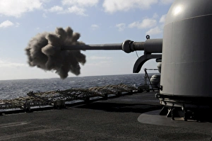 A 76mm cannon is fired aboard the guided missile frigate USS Simpson A 76mm cannon is fired aboard the guided missile frigate USS Simpson