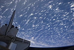 The aft section of space shuttle Discovery backdropped by planet Earth The aft section of space shuttle Discovery backdropped by planet Earth