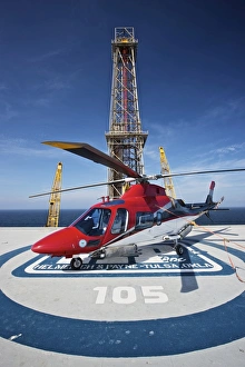 AgustaWestland AW109E utility helicopter on the helipad of an oil rig AgustaWestland AW109E utility helicopter on the helipad of an oil rig