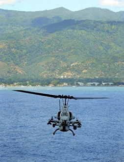 An AH-1W Super Cobra flies off the coast of Dili, East Timor An AH-1W Super Cobra flies off the coast of Dili, East Timor