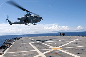 An AH-1W Super Cobra helicopter lands aboard USS Denver An AH-1W Super Cobra helicopter lands aboard USS Denver
