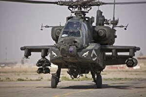 Ah 64 Collection: An AH-64 Apache helicopter returns from a mission over Iraq