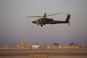 An AH-64D Apache Longbow Block III flies by the control tower on Camp Speicher An AH-64D Apache Longbow Block III flies by the control tower on Camp Speicher