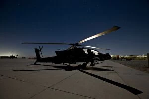 Ah 64 Collection: An AH-64D Apache Longbow Block III on the flight line at night