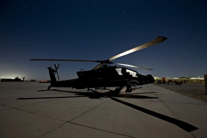 An AH-64D Apache Longbow Block III on the flight line at night An AH-64D Apache Longbow Block III on the flight line at night