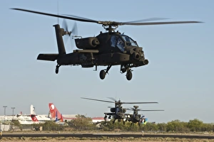 AH-64D Apache Longbow helicopters taking off on a mission AH-64D Apache Longbow helicopters taking off on a mission