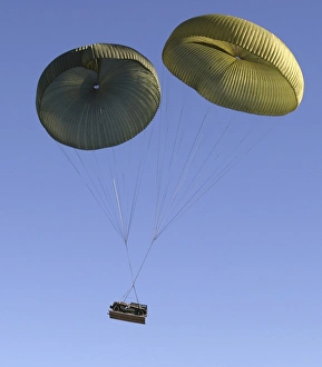 Air Delivery Platoon drops heavy equipment from a C-17 Air Delivery Platoon drops heavy equipment from a C-17