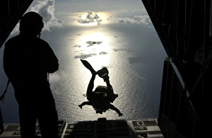 An Air Force pararescueman jumps out of the back of an HC-130 Hercules An Air Force pararescueman jumps out of the back of an HC-130 Hercules