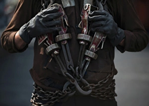 Airman carries aircraft tie-down chains on the flight deck of USS Carl Vinson Airman carries aircraft tie-down chains on the flight deck of USS Carl Vinson