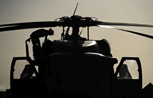 An Airman conducting a preflight inspection of an HH-60G Pave Hawk An Airman conducting a preflight inspection of an HH-60G Pave Hawk