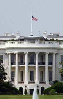 The American flag flies at half-staff atop the White House The American flag flies at half-staff atop the White House