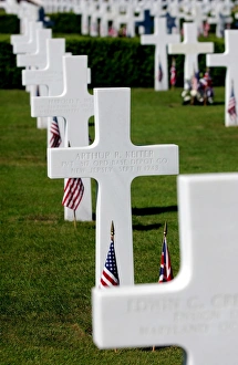 American flags rest in front of headstones at Madingley American Cemetery American flags rest in front of headstones at Madingley American Cemetery