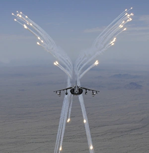 An AV-8B Harrier fires flares during a training flight An AV-8B Harrier fires flares during a training flight