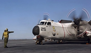 Aviation Boatswain Mate directs a C-2A Greyhound on the flight deck aboard USS Ronald Aviation Boatswain Mate directs a C-2A Greyhound on the flight deck aboard USS Ronald