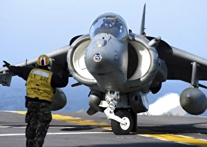 Aviation Boatswains Mate directs an AV-8B Harrier Aviation Boatswains Mate directs an AV-8B Harrier