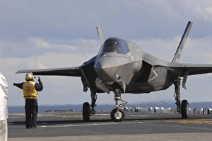 An aviation boatswains mate directs an F-35B Lightning II aboard USS Wasp An aviation boatswains mate directs an F-35B Lightning II aboard USS Wasp