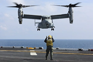 An aviation boatswains mate directs the landing of an MV-22 Osprey An aviation boatswains mate directs the landing of an MV-22 Osprey