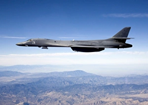 A B-1B Lancer carries the Sniper pod on its belly as it flies through the sky A B-1B Lancer carries the Sniper pod on its belly as it flies through the sky