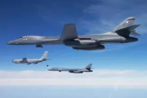 A B-1B Lancer stands by as another Lancer connects with a KC-135 Stratotanker A B-1B Lancer stands by as another Lancer connects with a KC-135 Stratotanker