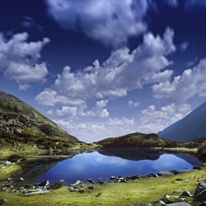 Blue lake in the Pirin Mountains over tranquil clouds, Pirin National Park, Bulgaria Blue lake in the Pirin Mountains over tranquil clouds, Pirin National Park, Bulgaria