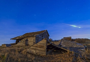 A bright bolide meteor breaking up as it enters the atmosphere A bright bolide meteor breaking up as it enters the atmosphere