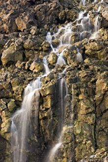 Brine falls from volcanic rock drop off to a runoff stream Brine falls from volcanic rock drop off to a runoff stream