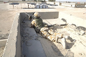A British soldier provides security from a rooftop in Basra, Iraq A British soldier provides security from a rooftop in Basra, Iraq