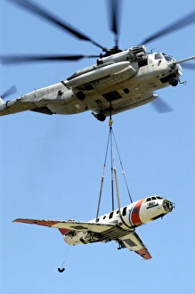 A CH-53 Sea Stallion lifts a HU-25 Guardian Coast Guard aircraft A CH-53 Sea Stallion lifts a HU-25 Guardian Coast Guard aircraft