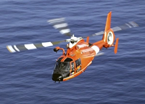 A Coast Guard HH-65A Dolphin rescue helicopter in flight A Coast Guard HH-65A Dolphin rescue helicopter in flight