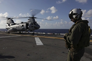 A crew chief watches a CH-46E Sea Knight helicopter aboard USS Makin Island A crew chief watches a CH-46E Sea Knight helicopter aboard USS Makin Island