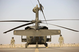 Crew Chiefs stand beside their UH-60L Black Hawk helicopter Crew Chiefs stand beside their UH-60L Black Hawk helicopter