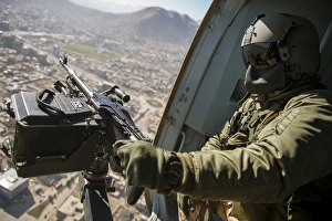 Czech Air Force door gunner scans the ground from a Mi-17 helicopter Czech Air Force door gunner scans the ground from a Mi-17 helicopter