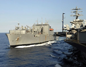 Dry cargo and ammunition ship USNS Wally Schirra transits alongside aircraft carrier Dry cargo and ammunition ship USNS Wally Schirra transits alongside aircraft carrier