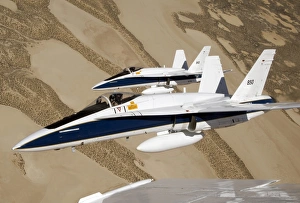 Two Dryden F/A-18s fly in tight formation over the desert Two Dryden F/A-18s fly in tight formation over the desert