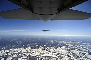 Two EC-130J Commando Solo aircraft fly in formation Two EC-130J Commando Solo aircraft fly in formation